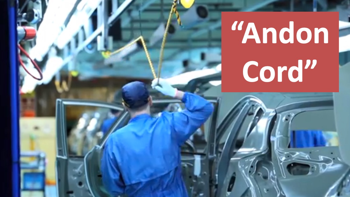 Toyota factory worker pulling an andon cord